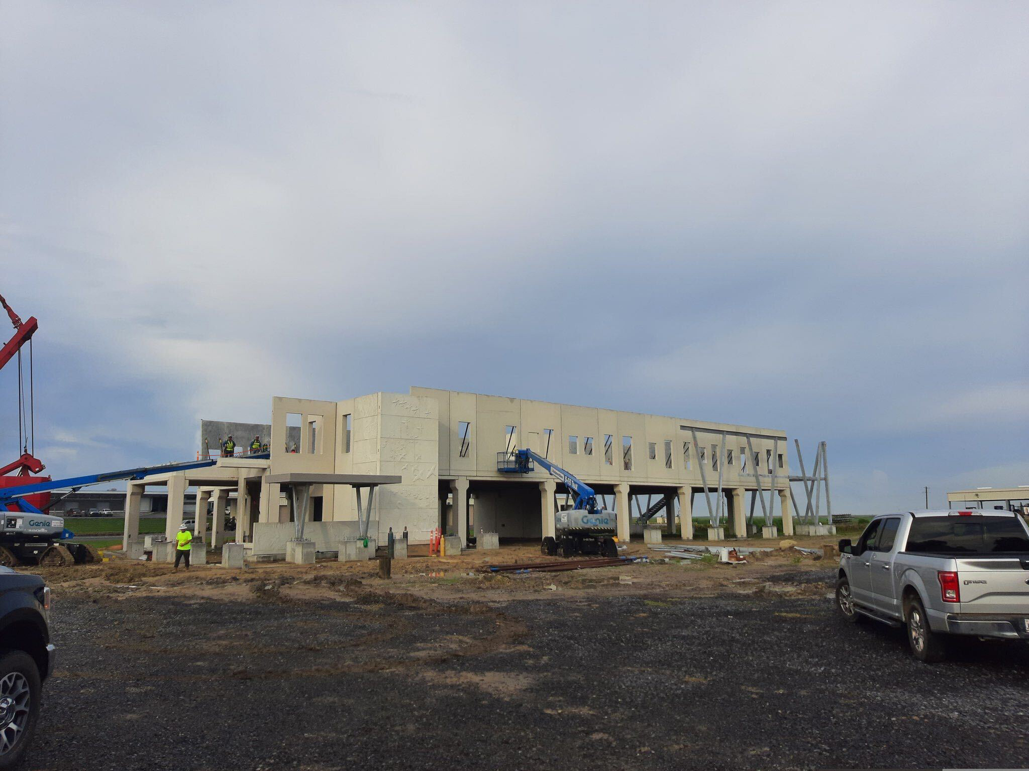 in progress precast concrete structure located next to a body of water in a marsh